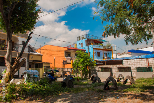 Local street with houses in the Philippines capital Manila photo