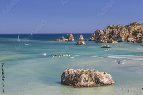 Canvastavla Canoes in the turquoise water of the Atlantic Ocean surrounding Praia Dona Ana b