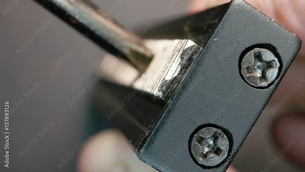 Close up of a screwdriver screwing a bolt
Close up of a screwdriver screwing a bolt