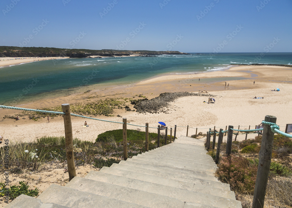 Fototapeta premium View of the sandy beach of Vila Nova de Milfontes surrounded by the blue ocean Odemira Alentejo region Portugal Europe