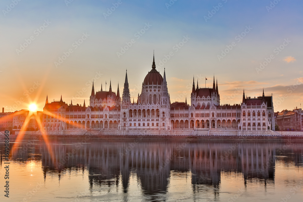 Parliament and riverside in Budapest Hungary during sunrise with sunbeams
