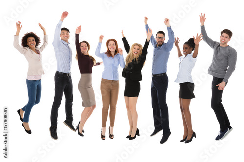 Portrait Of Excited College Students Raising Their Arms