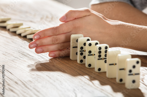 Businesswoman Supports Domino From Falling