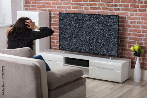 Woman Getting Frustrated With Glitch TV Screen
