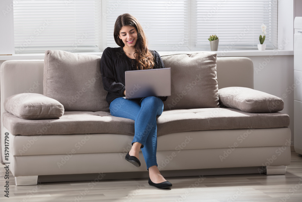 Smiling Woman Using Laptop At Home Smiling Woman Using Laptop At Home
