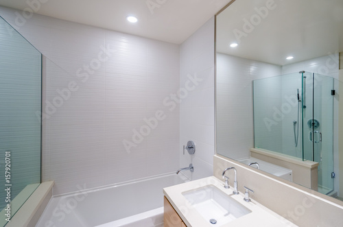 Modern bathroom interior with bathtub  sinks  and shower cabin.