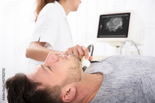 Man Getting Ultrasound Of A Thyroid From Doctor