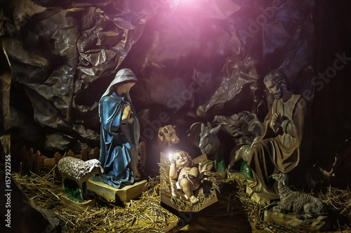 Baby Jesus lying in crib in divine light © Volodymyr