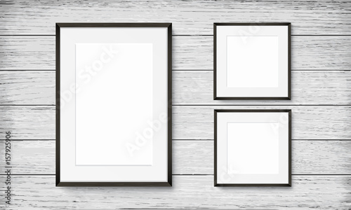 Set of black frames on wooden background