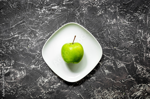 healthy food with green vegetables, fruits for dinner on dark table background top view photo