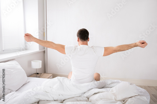 Rear View Of A Man Wake Up In Bed