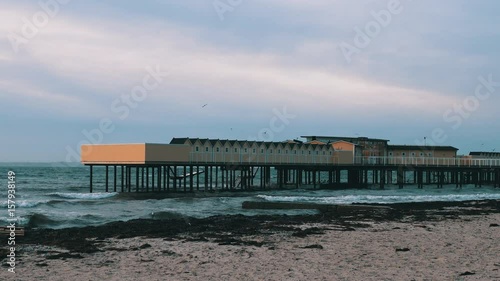 Open air bath building and pier in Helsingborg, Sweden. Windy weather, sea waves photo