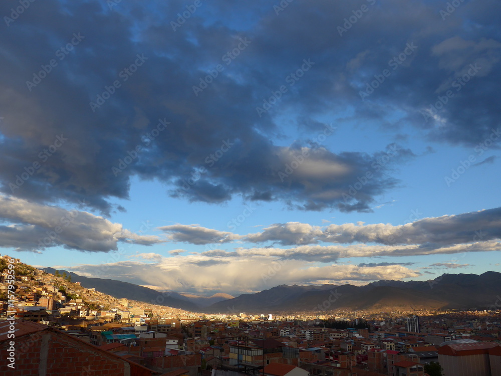 Late afternoon sun hitting clouds above the Cusco skyline in the Peruvian Andes. 