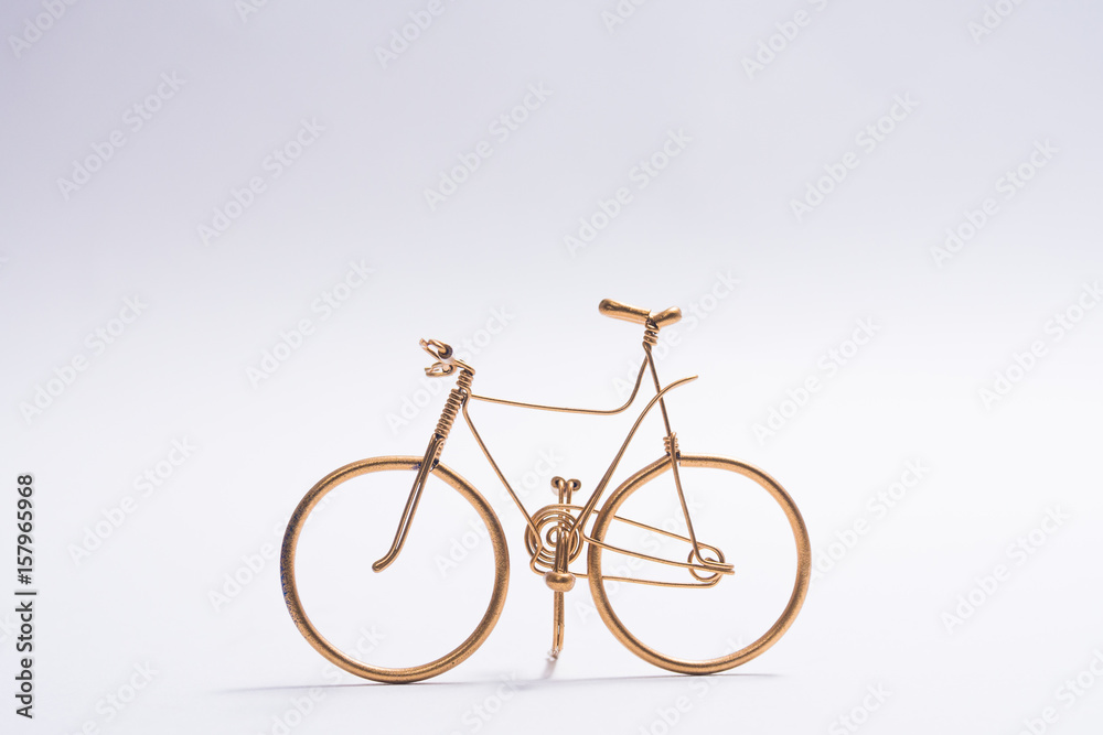 golden wire bicycle handmade on white background