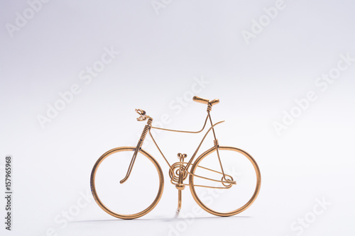 golden wire bicycle handmade on white background