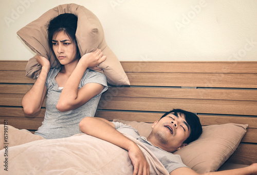 A woman has a nuisance to the man he loves sleeping loud snoring.Concept of life together