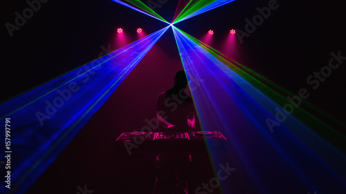 Disc jockey, DJ, Silhouette on laser beams