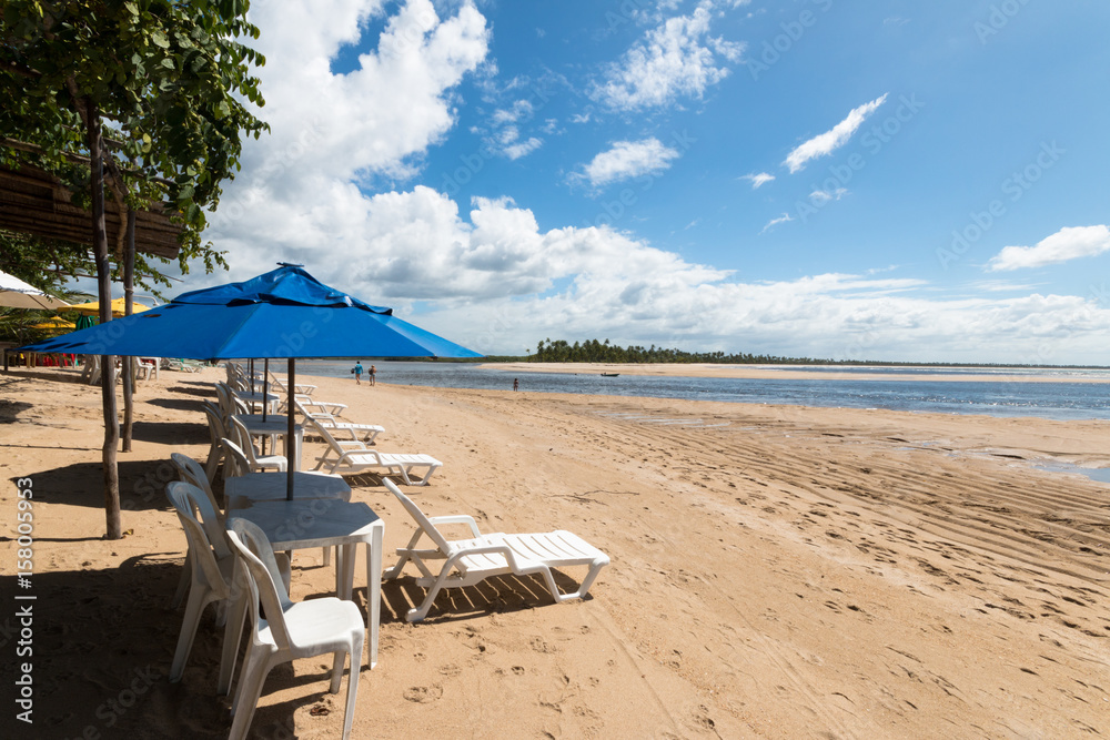 Umbrella and beach chairs on tropical island Umbrella and beach chairs on tropical island