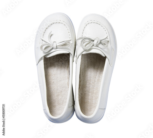 Lady white leather shoes isolated on a white, top view