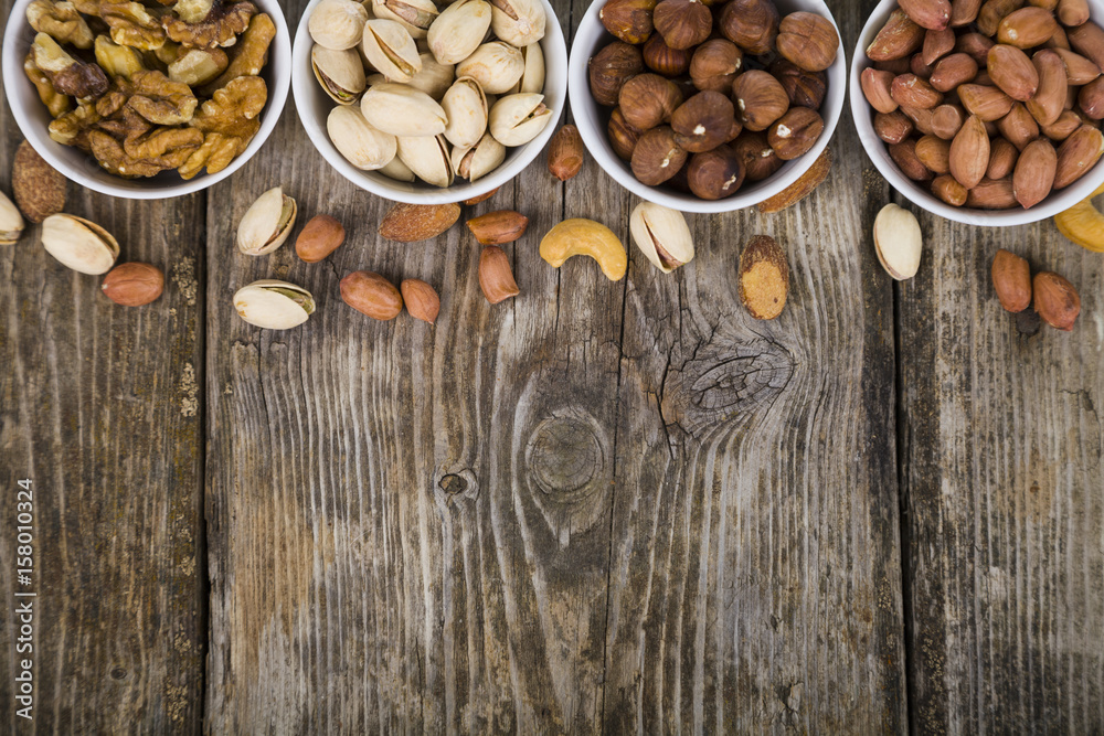 Nuts in a plates on a wooden table Nuts in a plates on a wooden table