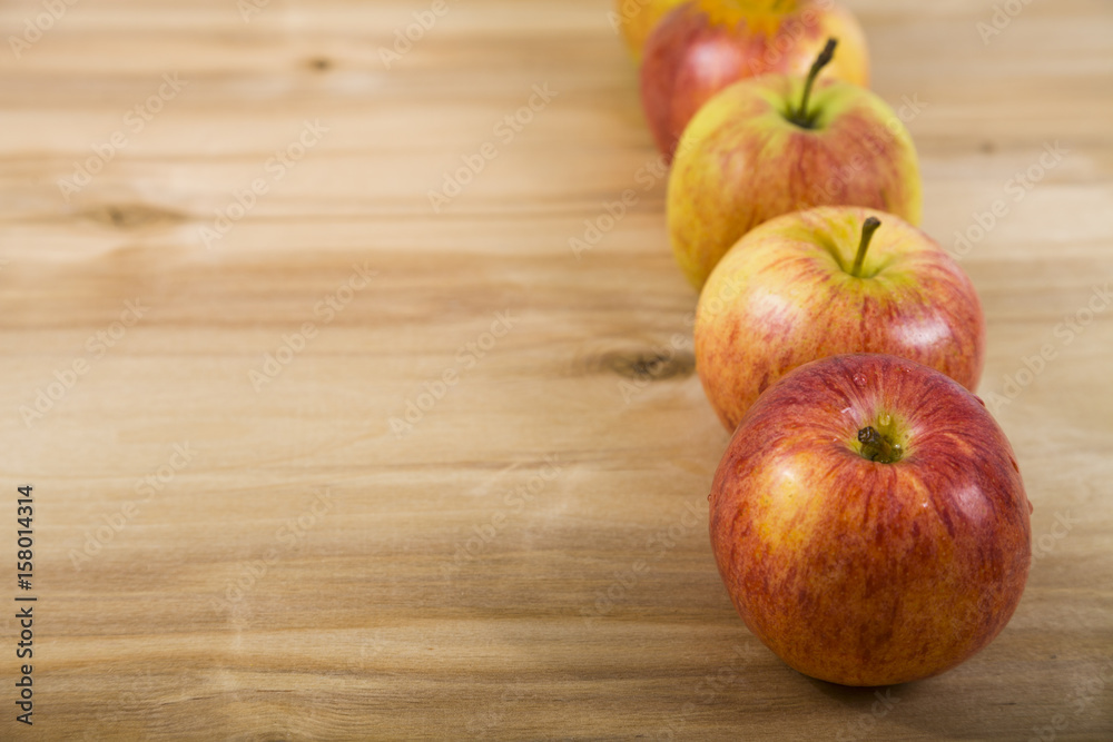 Red apples on a wooden table . Red apples on a wooden table .