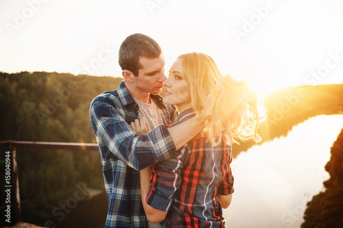 Romantic photo of a young couple in checkered shirts