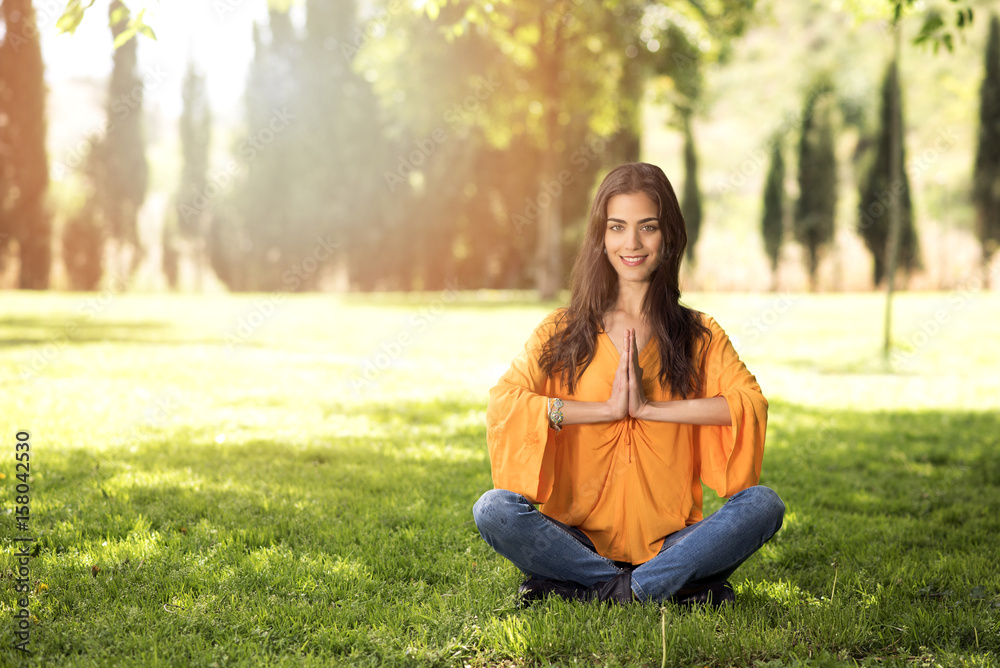 beautiful girl doing yoga exercises in a park beautiful girl doing yoga exercises in a park