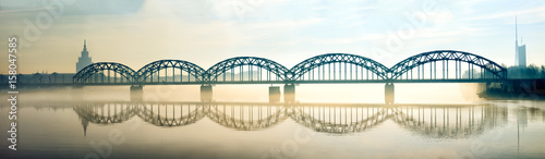 Silhouette of Riga Railway bridge in foggy early morning