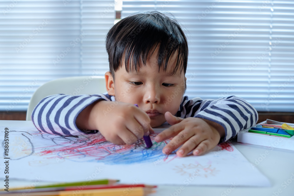 Asian Little child drawing on the paper Asian Little child drawing on the paper