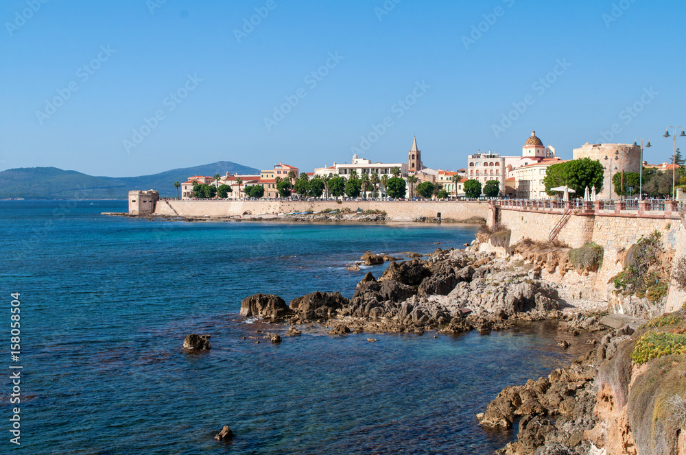 Alghero, Sardegna - waterfront with a wall and a view of the historic city