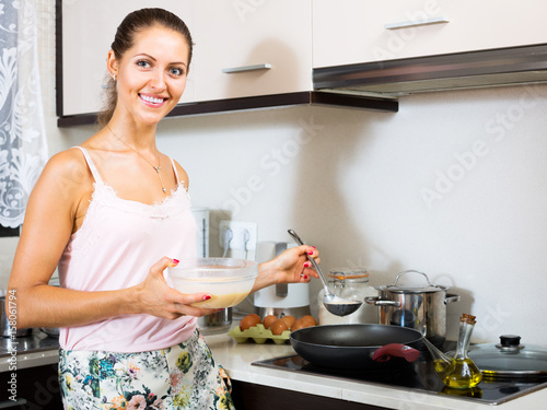 housewife frying omelette