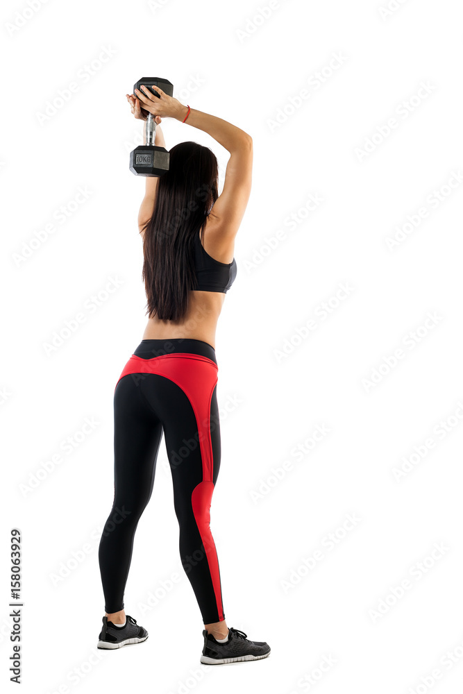 Sports woman fitness model doing exercises with dumbbells, hands behind head in semi-bent position, side view on white background. Examples of exercises with dumbbells Sports woman fitness model doing exercises with dumbbells, hands behind head in semi-bent position, side view on white background. Examples of exercises with dumbbells