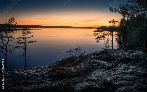 Scenic landscape over lake with sunset at spring evening in Finland