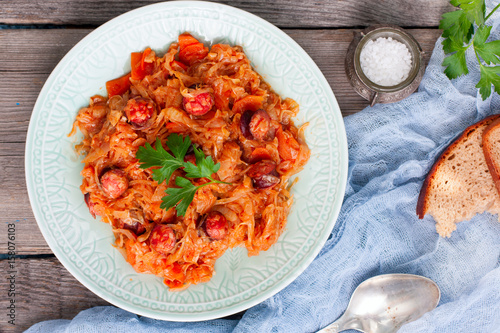 Stewed cabbage with sausages, German cuisine, horizontal, top view
