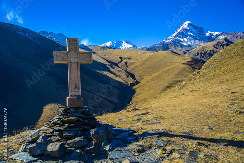 Cross in Kazbegi with view of mountain Kazbek.