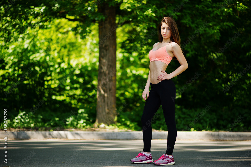 Fitness sport girl in sportswear posed at road in park, outdoor sports, urban style. Fitness sport girl in sportswear posed at road in park, outdoor sports, urban style.