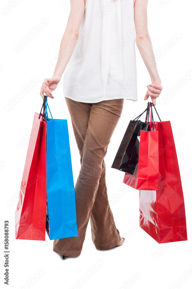Back view of shopping woman carrying gift bags