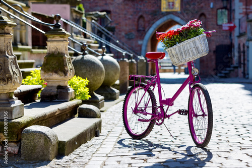 pink bike on an old street photo