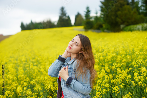 A young caucasian woman in rapeseed field