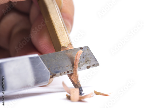sharpened wooden pencil by cutter knife  close-up on white background