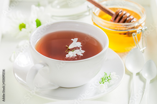 Hot tea with honey with spring flowers