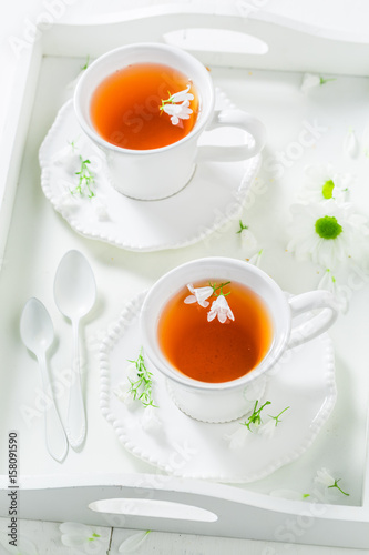 Healing tea with honey with spring flowers
