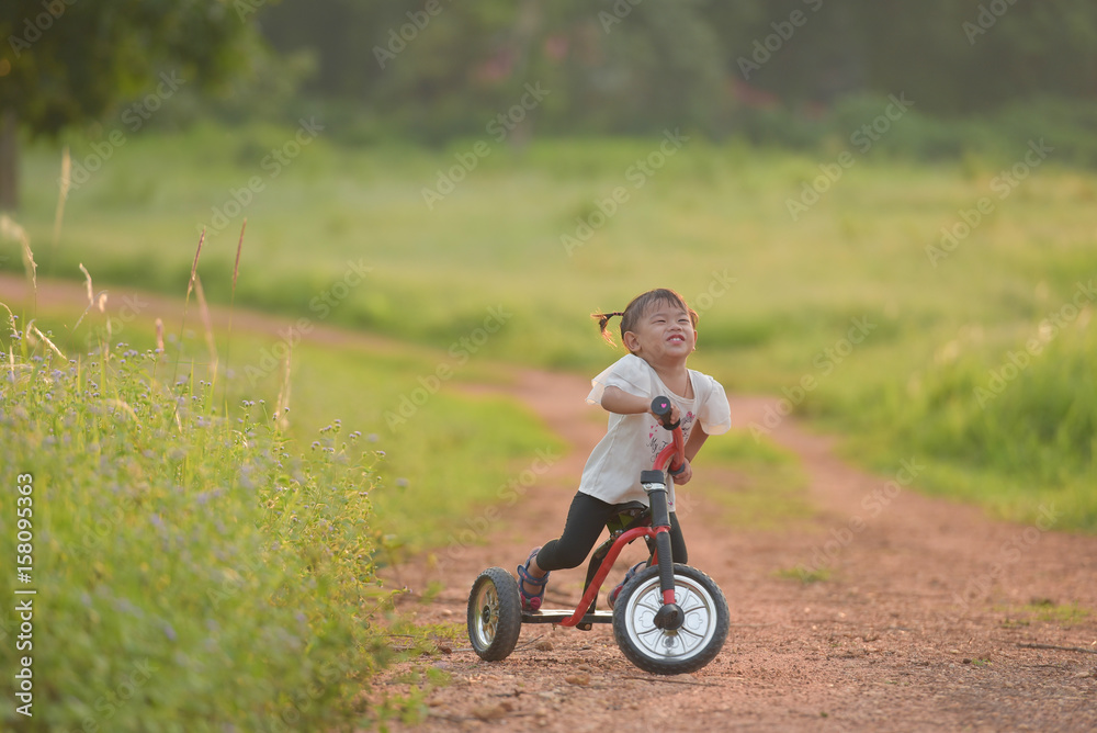 The girl is happy about cycling outside the home. The girl is happy about cycling outside the home.