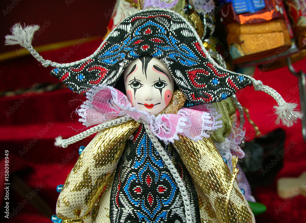 Pierrot doll horizontal portrait, beautiful artisan toy, with painted wooden face, and colorful clothes, at a souvenir market, in Saint Petersburg, Russia