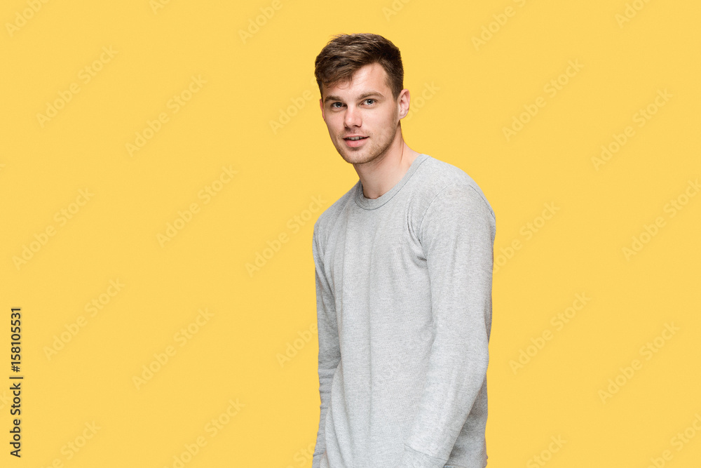 The young man smiling and looking at camera The young man smiling and looking at camera