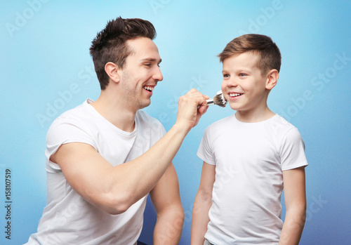 Father and son shaving on l...