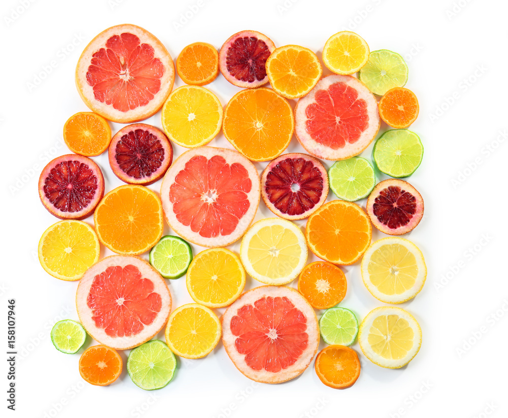 Slices of delicious citrus fruits on white background, top view Slices of delicious citrus fruits on white background, top view