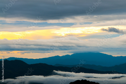 Landscape of sunrise and foggy over the mountain.