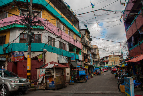 Local street with houses in the Philippines capital Manila photo