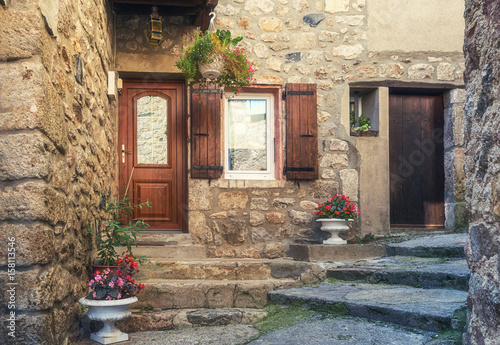 The entrance  of a house in a narrow street of the picturesque village of Antraigues-sur-Volane